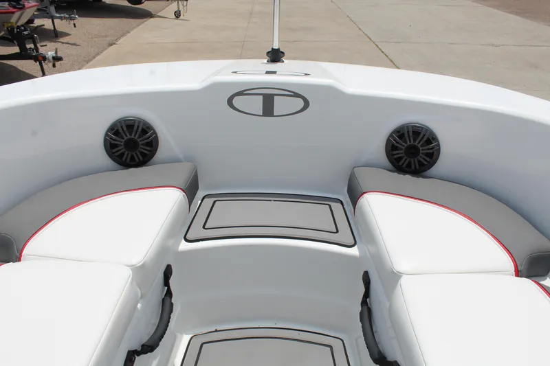 Slide: The Image of 2023 Tahoe T18 boat interior with white seating and speakers. - 17