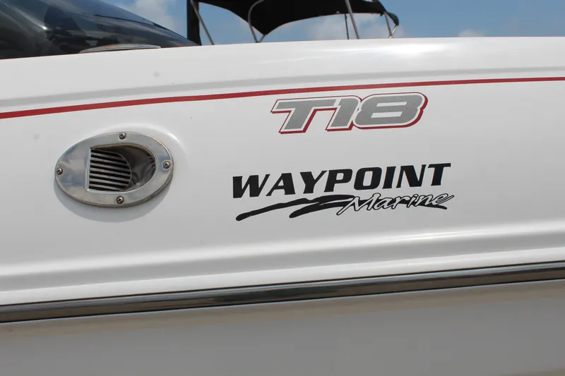 Slide: The Image of 2023 Tahoe T18 boat with Waypoint Marine branding on the side. - 19