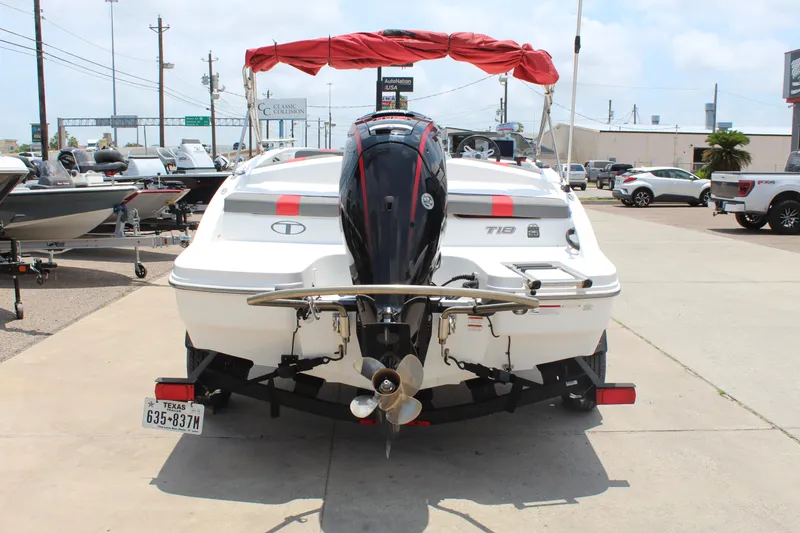 Slide: The Image of 2023 Tahoe T18 boat with outboard motor, displayed in a dealership lot. - 6