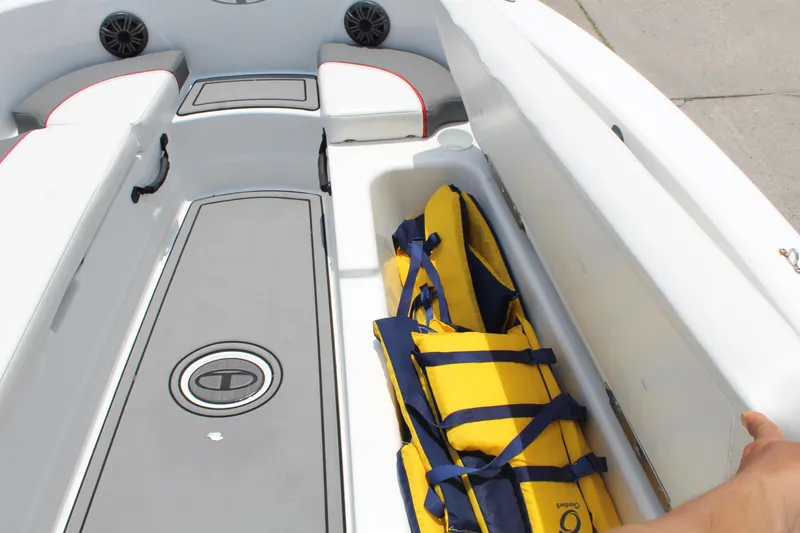 Slide: The Image of 2023 Tahoe T18 boat interior with yellow life jackets in storage compartment. - 9