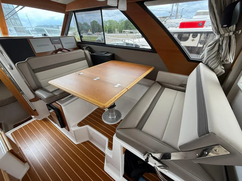 Slide: The Image of Interior of 2023 Cutwater C-32 CB boat with seating and wooden table. - 10