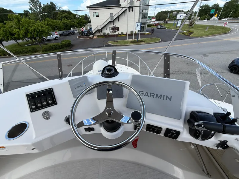Slide: The Image of 2023 Cutwater C-32 CB helm with Garmin navigation system and steering wheel. - 18