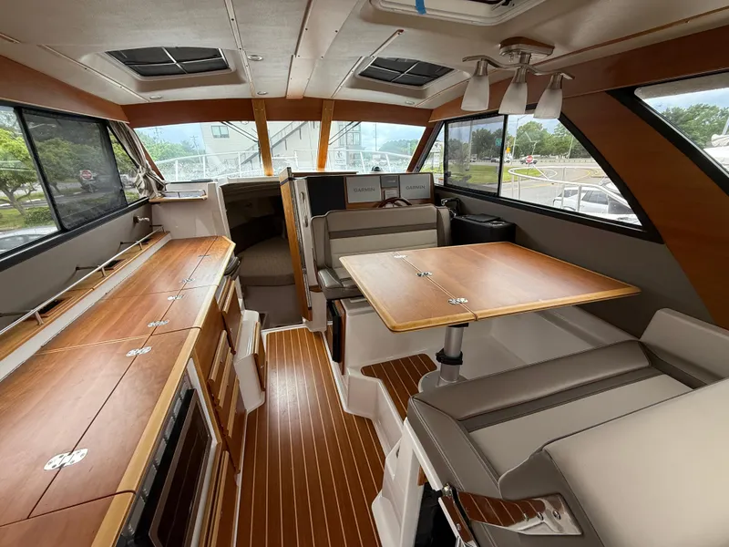 Slide: The Image of 2023 Cutwater C-32 CB interior with wood finishes and seating area. - 20