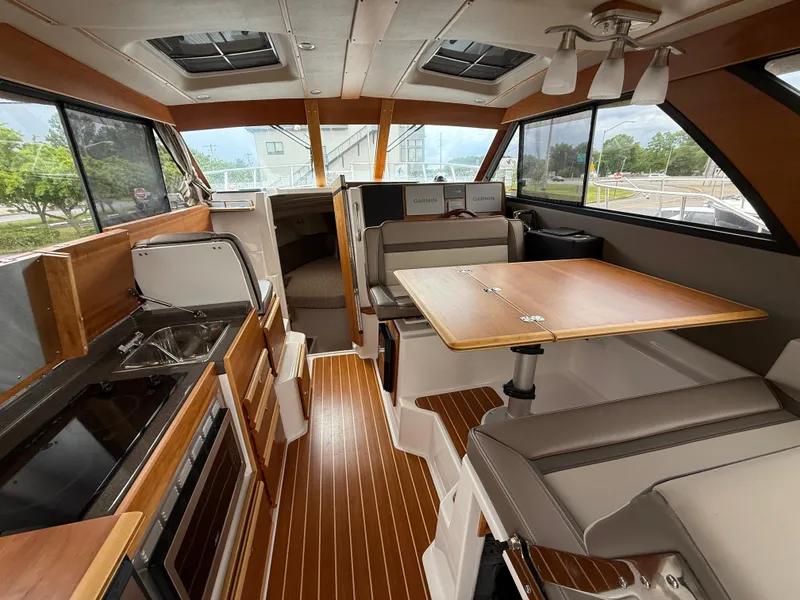 Slide: The Image of Interior of 2023 Cutwater C-32 CB boat with modern kitchen and dining area. - 21