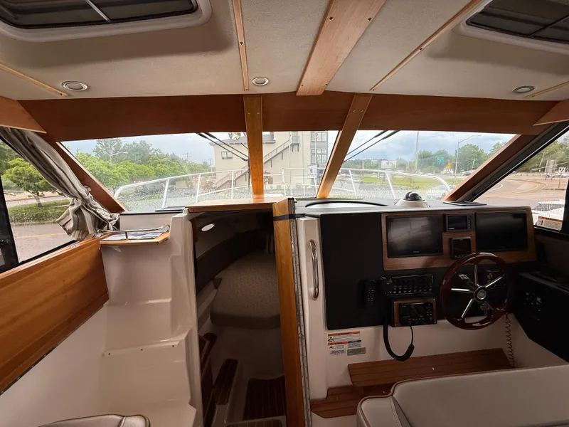 Slide: The Image of 2023 Cutwater C-32 CB boat interior with helm, steering wheel, and navigation equipment. - 25