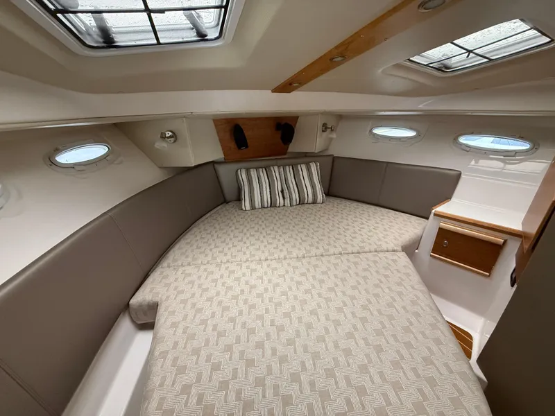 Slide: The Image of 2023 Cutwater C-32 CB cabin interior with cozy bed and skylights. - 27