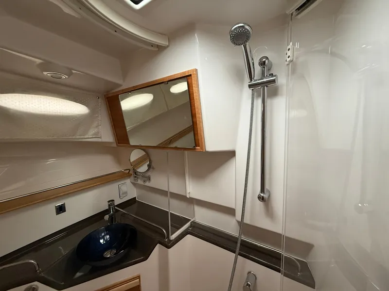 Slide: The Image of 2023 Cutwater C-32 CB bathroom with modern sink, mirror, and showerhead. - 30