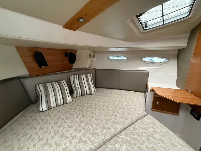 Slide: The Image of 2023 Cutwater C-32 CB cabin interior with striped pillows and modern design. - 32