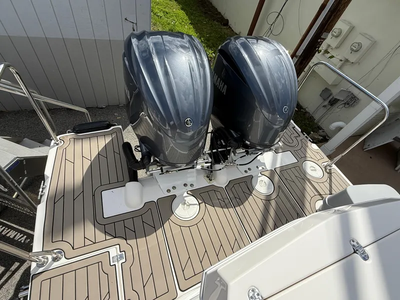 Slide: The Image of 2023 Cutwater C-32 CB boat with dual outboard engines on a teak deck. - 5
