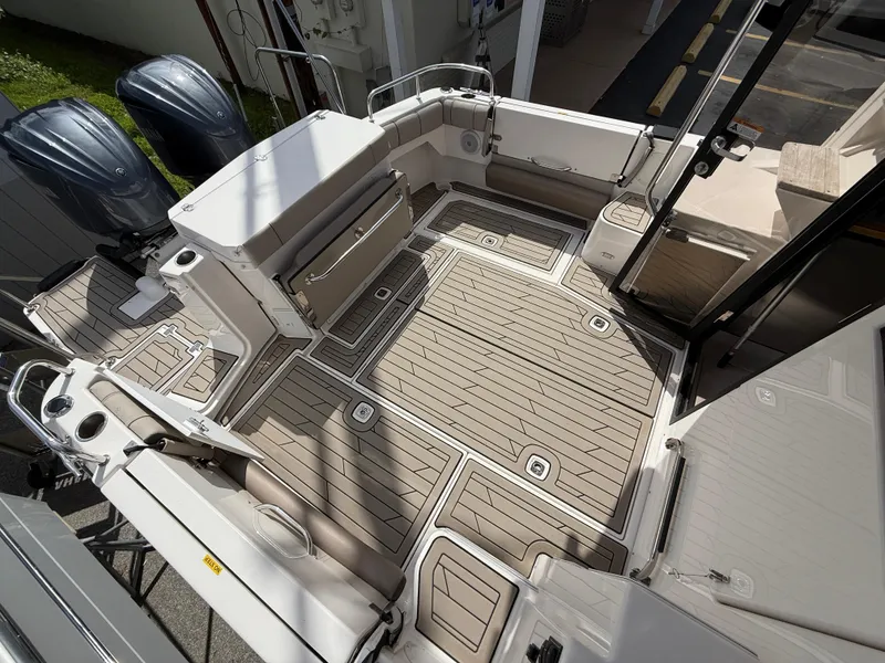 Slide: The Image of 2023 Cutwater C-32 CB boat deck with sleek design and dual outboard motors. - 6