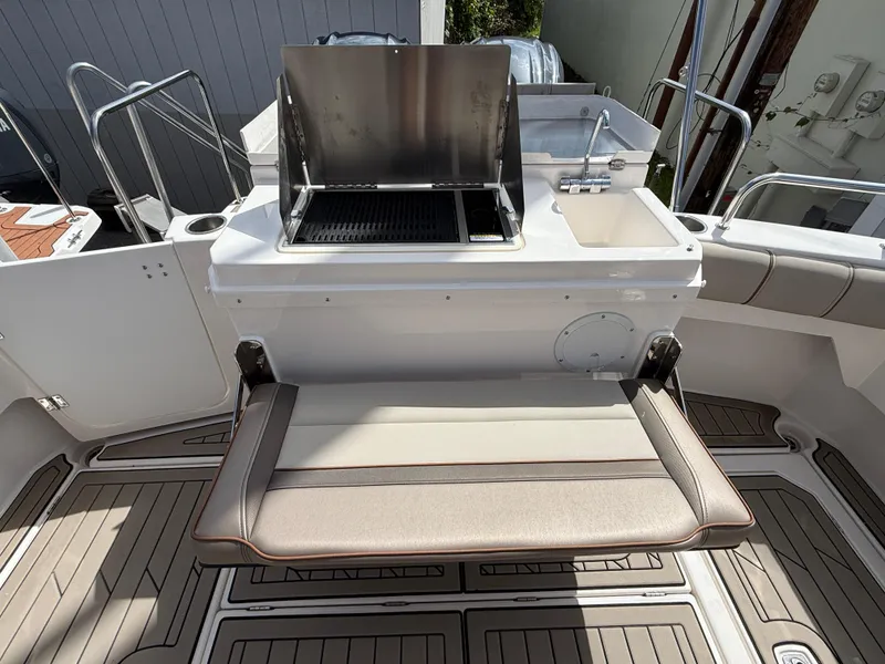 Slide: The Image of 2023 Cutwater C-32 CB boat deck with grill, sink, and seating area. - 9