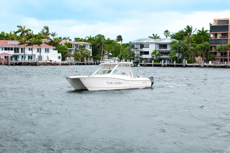 Slide: The Image of 2019 World Cat 296DC boat cruising near waterfront homes. - 11