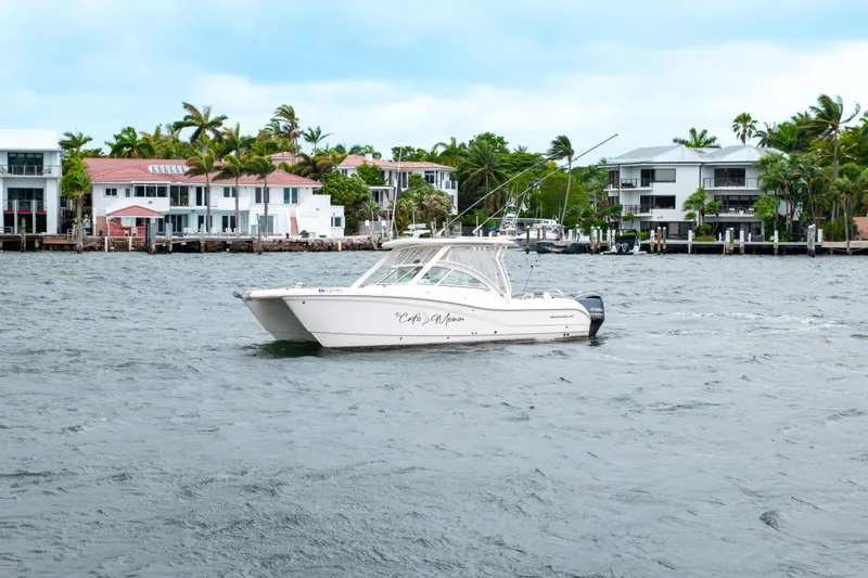 Slide: The Image of 2019 World Cat 296DC boat cruising near waterfront homes. - 13