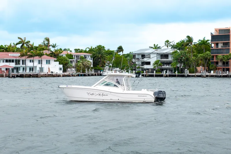 Slide: The Image of 2019 World Cat 296DC boat on water near waterfront homes. - 15