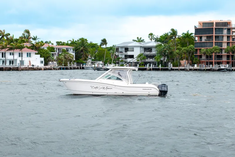 Slide: The Image of 2019 World Cat 296DC boat cruising near waterfront homes. - 16