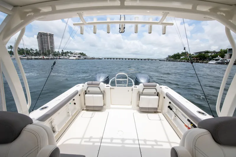 Slide: The Image of 2019 World Cat 296DC boat interior with ocean view, featuring spacious seating and fishing rods. - 24