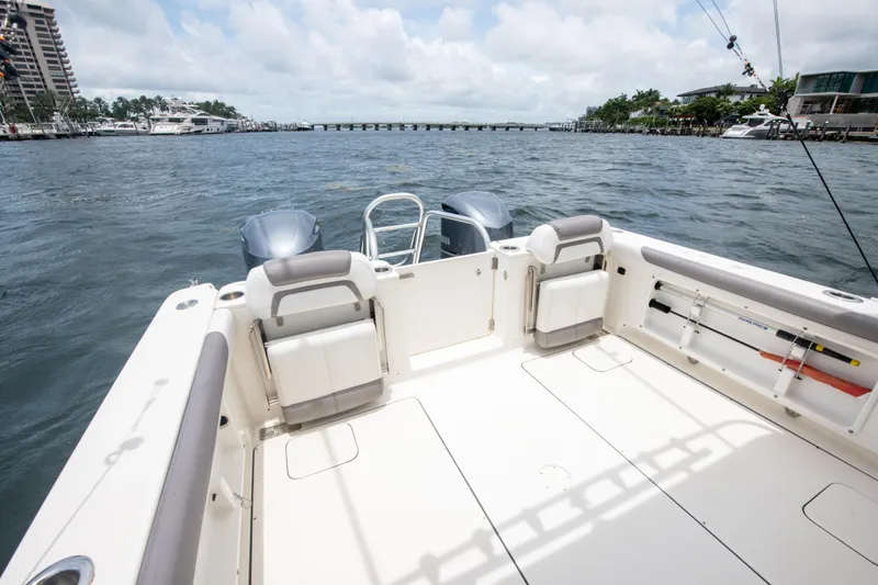 Slide: The Image of 2019 World Cat 296DC boat deck with ocean view and fishing rods. - 25