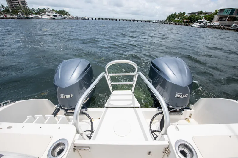 Slide: The Image of 2019 World Cat 296DC boat with twin 300 horsepower engines on open water. - 27