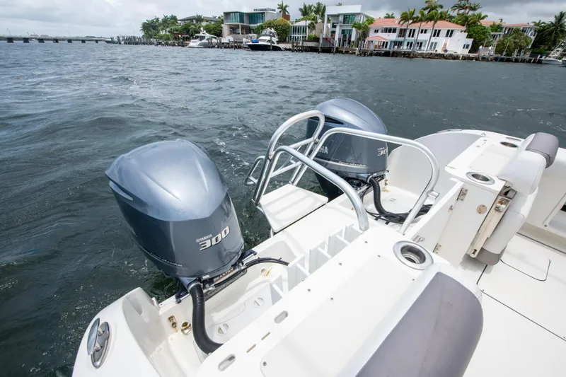 Slide: The Image of 2019 World Cat 296DC boat with dual 300 horsepower engines on a scenic waterfront. - 29