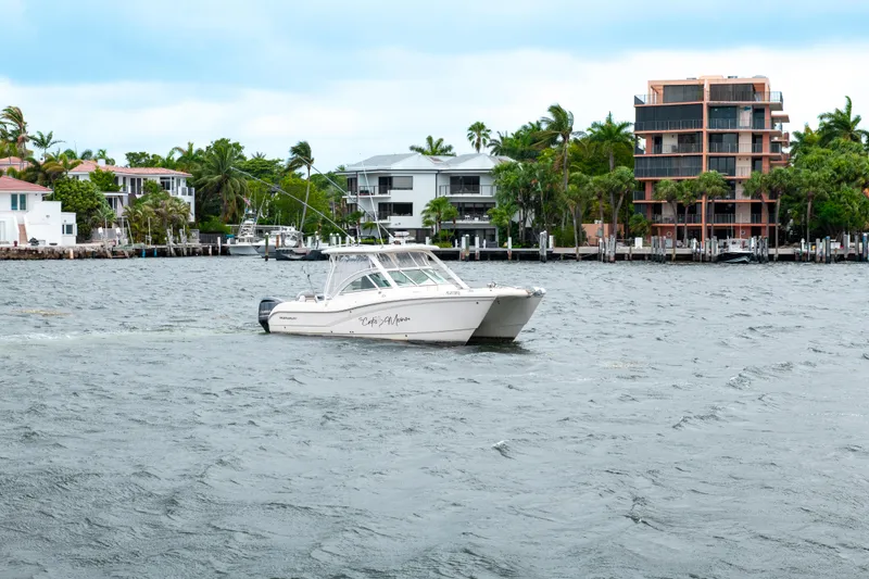 Slide: The Image of 2019 World Cat 296DC boat cruising near waterfront homes. - 3