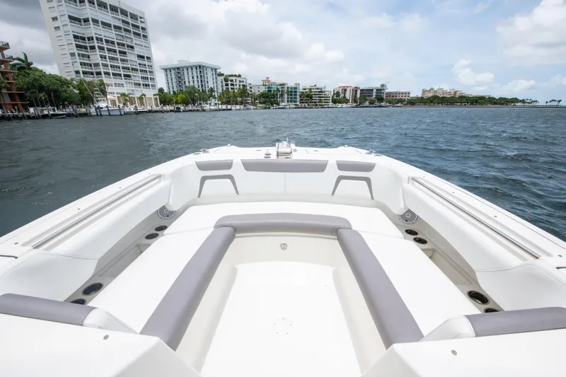 Slide: The Image of 2019 World Cat 296DC boat with spacious seating, cruising near urban waterfront. - 30