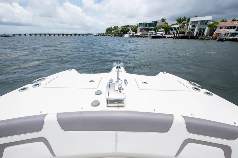 Slide: The Image of Bow view of 2019 World Cat 296DC boat on water near waterfront homes. - 37