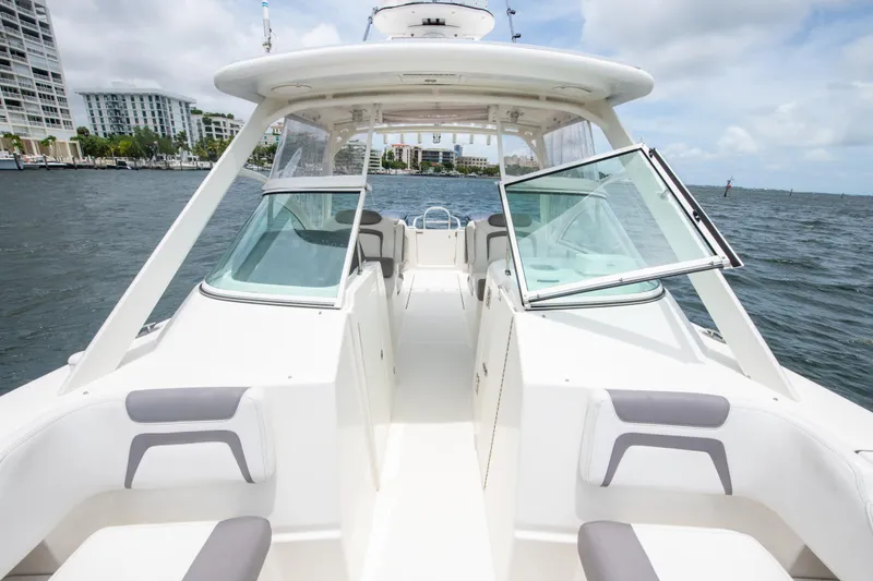 Slide: The Image of 2019 World Cat 296DC boat on water, featuring spacious seating and modern design. - 38