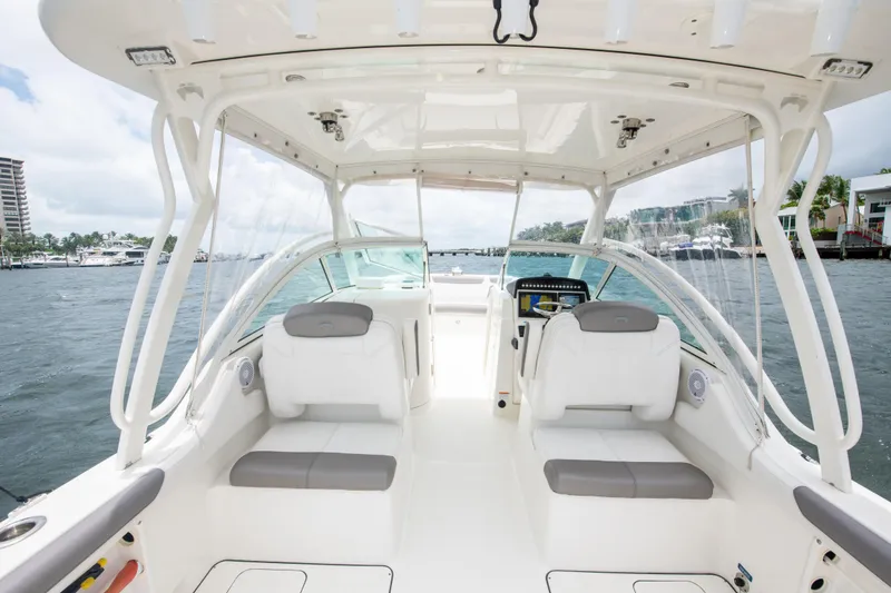 Slide: The Image of 2019 World Cat 296DC boat interior with white seating and open water view. - 43