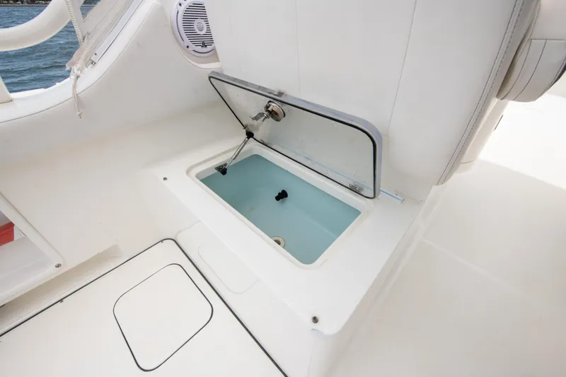 Slide: The Image of 2019 World Cat 296DC boat interior with open storage compartment. - 44