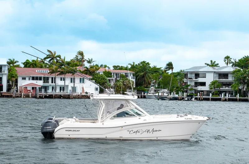 Slide: The Image of 2019 World Cat 296DC boat cruising near waterfront homes. - 46