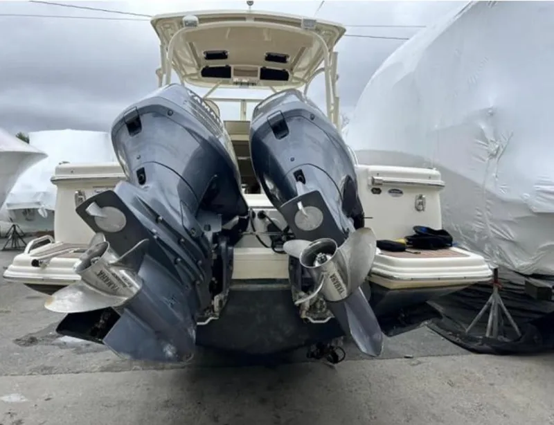 Slide: The Image of 2012 Scout 262 Abaco boat with dual outboard motors, docked and covered. - 5