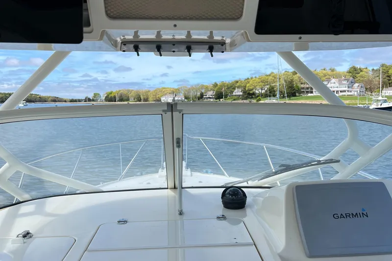 Slide: The Image of 2012 Scout 262 Abaco boat cockpit view with Garmin navigation, overlooking calm waters and shoreline. - 9