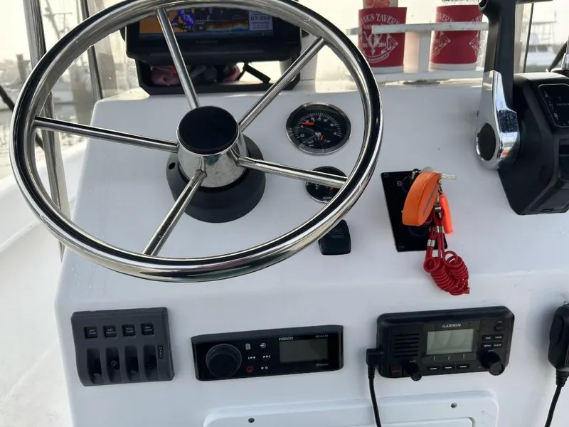 Slide: The Image of 2024 C-Hawk 19 Center Console dashboard with steering wheel and navigation controls. - 12