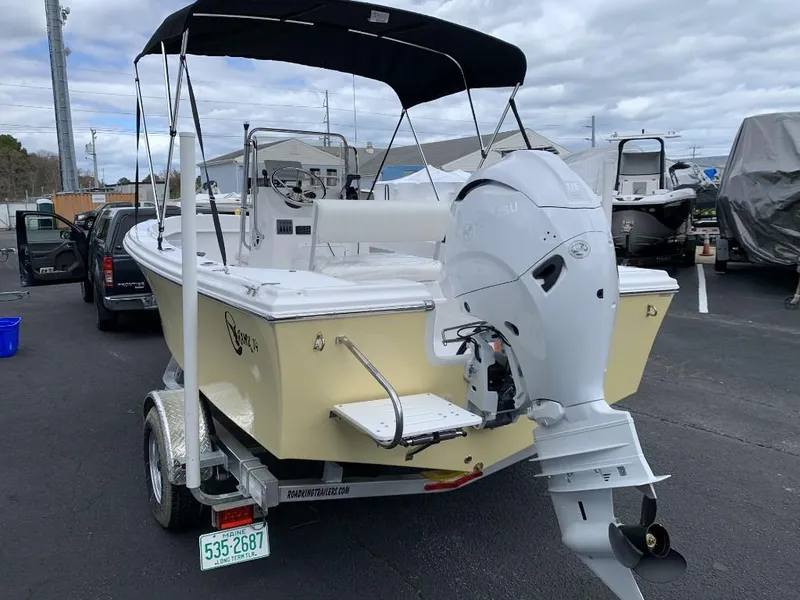 Slide: The Image of 2024 C-Hawk 19 Center Console boat with outboard motor on trailer. - 3