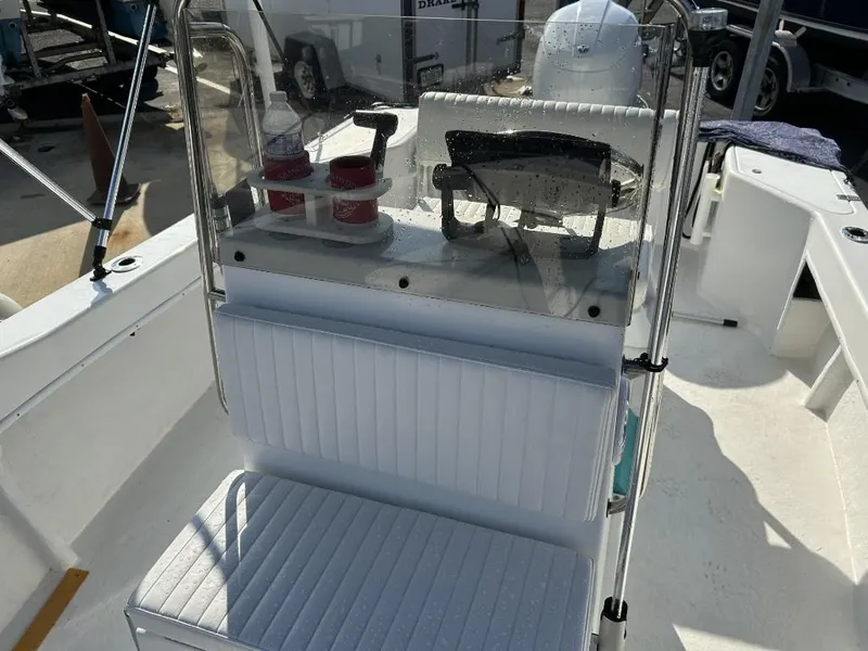 Slide: The Image of 2024 C-Hawk 19 Center Console boat interior with steering controls and seating. - 6