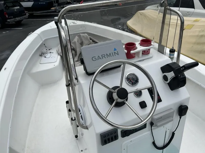 Slide: The Image of 2024 C-Hawk 19 Center Console boat with Garmin navigation system and steering wheel. - 7