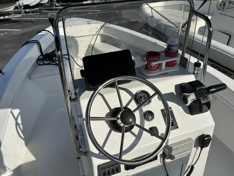 Slide: The Image of 2024 C-Hawk 19 Center Console boat steering wheel and controls, featuring modern navigation equipment. - 8