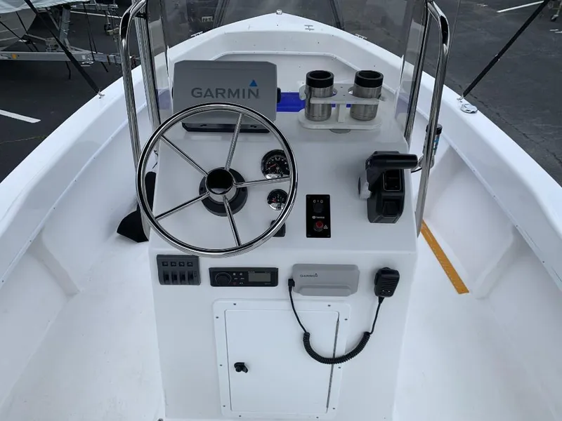 Slide: The Image of 2024 C-Hawk 19 Center Console boat with Garmin navigation system and steering wheel. - 9