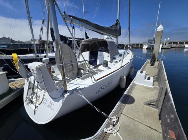 The Image of 2002 Beneteau First 36.7 sailboat docked in a marina under clear blue skies. - 1