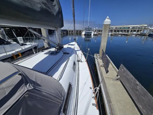Slide: The Image of Sailboat Beneteau First 36.7, 2002 model, docked at marina under clear blue sky. - 11