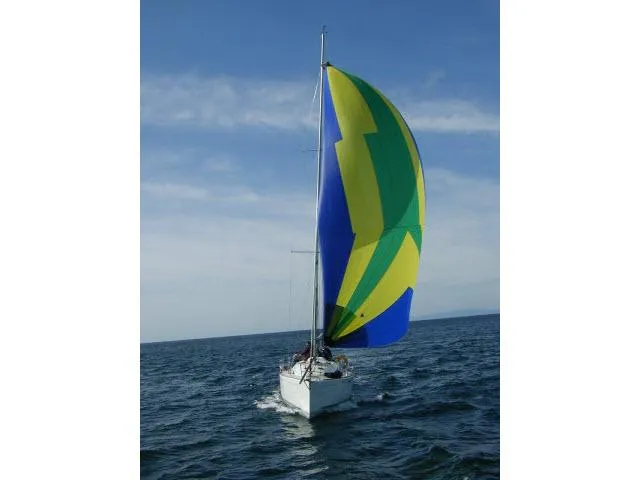 Slide: The Image of Sailing yacht Beneteau First 36.7 (2002) with colorful spinnaker on open water. - 19