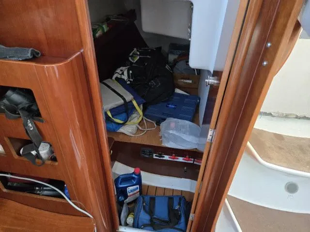 Slide: The Image of Interior storage area of a 2002 Beneteau First 36.7 sailboat with various equipment. - 8