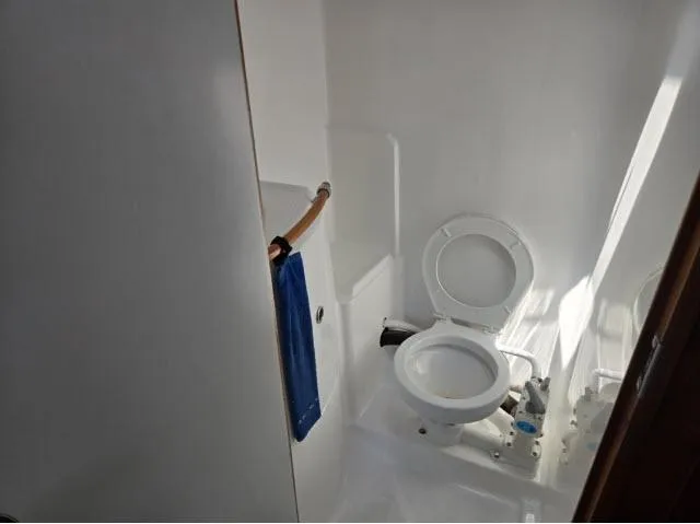 Slide: The Image of Bathroom interior of 2002 Beneteau First 36.7 yacht, featuring a compact marine toilet. - 9
