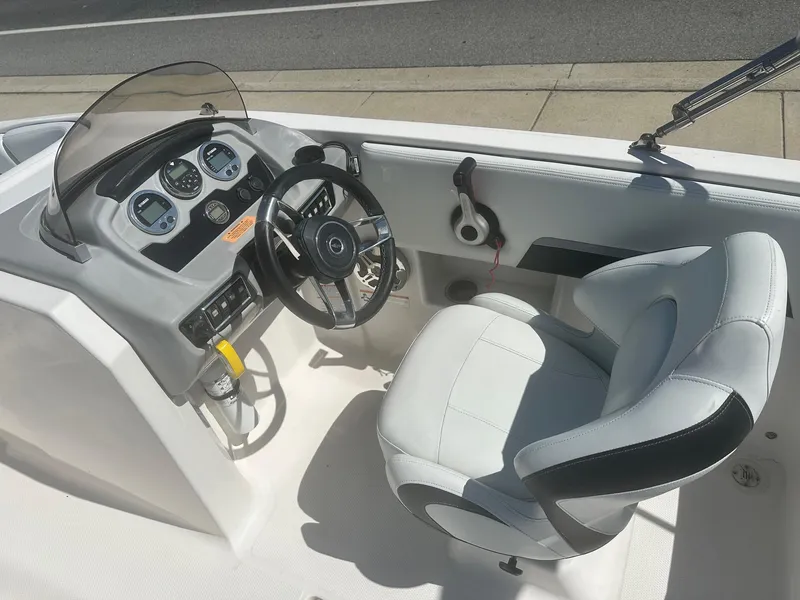Slide: The Image of 2018 Chaparral 191 Suncoast boat cockpit with steering wheel and gauges. - 10