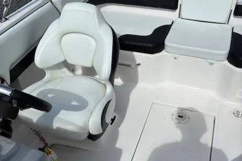 Slide: The Image of 2018 Chaparral 191 Suncoast boat interior with white seating and steering wheel. - 11