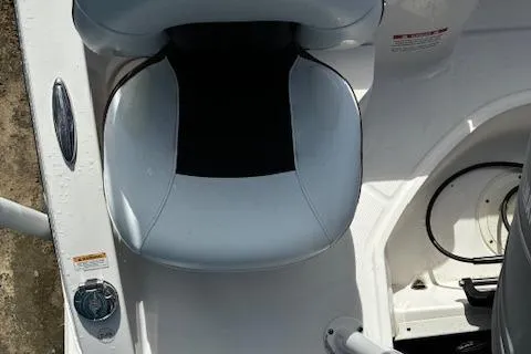 Slide: The Image of 2018 Chaparral 191 Suncoast boat seat and control panel, white and gray design. - 12
