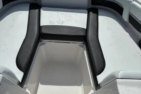Slide: The Image of 2018 Chaparral 191 Suncoast boat interior with cushioned seating and storage area. - 15