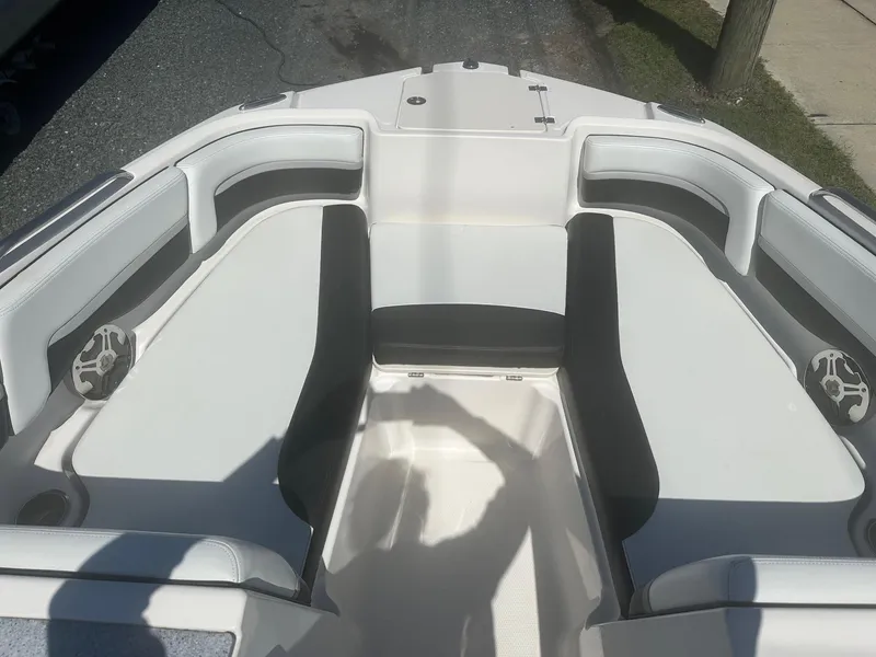 Slide: The Image of 2018 Chaparral 191 Suncoast boat interior with white seating and speaker system. - 16