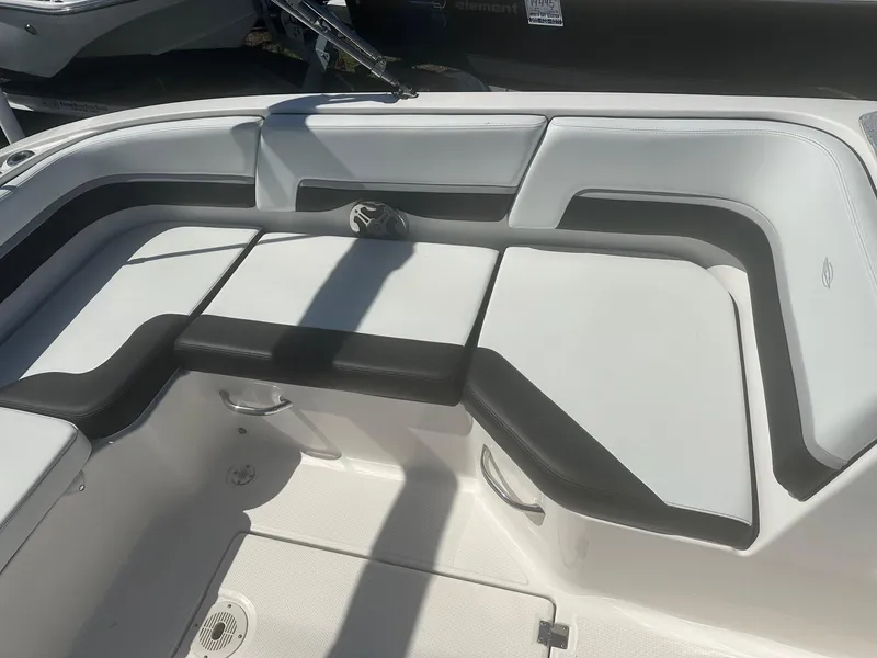 Slide: The Image of 2018 Chaparral 191 Suncoast boat interior seating with white and black upholstery. - 17