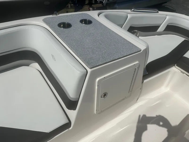 Slide: The Image of 2018 Chaparral 191 Suncoast boat interior with seating and cup holders. - 19